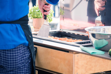 Chefs at work in a restaurant kitchen making delicious food