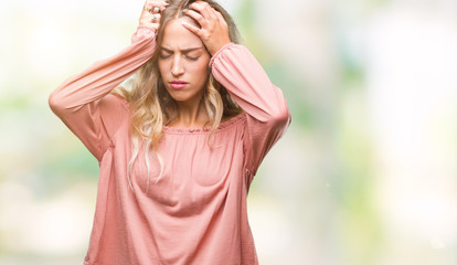 Beautiful young blonde woman over isolated background suffering from headache desperate and stressed because pain and migraine. Hands on head.