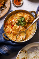 Indian cuisine: chicken tikka masala with rice and naan bread and spices.