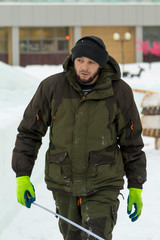 Assembler in overalls on the territory of the ice town