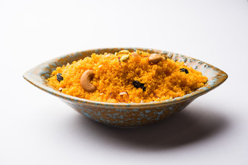 Badaam kesar shira / Sheera or almond saffron halwa, popular Indian dessert served in a bowl. selective focus