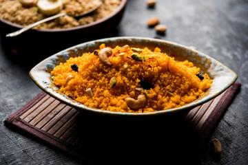 Badaam kesar shira / Sheera or almond saffron halwa, popular Indian dessert served in a bowl. selective focus