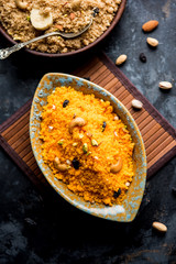Badaam kesar shira / Sheera or almond saffron halwa, popular Indian dessert served in a bowl. selective focus