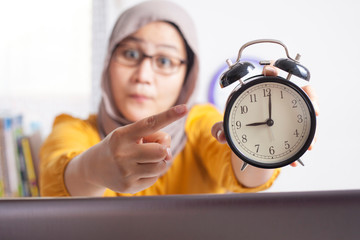 Young Businesswoman Pointing at Clock, Angry Expression