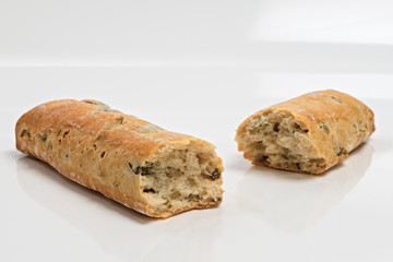 pane speciale italiano alle olive spezzato su fondo bianco da fronte