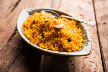 Badaam kesar shira / Sheera or almond saffron halwa, popular Indian dessert served in a bowl. selective focus