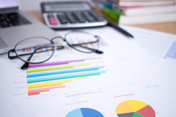 Picture of financial documents on a wooden table.