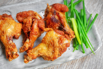 Fried chicken with BBQ sauce on a wooden background.