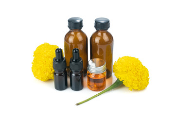 Marigold flowers extract (Tagetes erecta) with aromatherapy essential oil in Small bottle isolated on white background