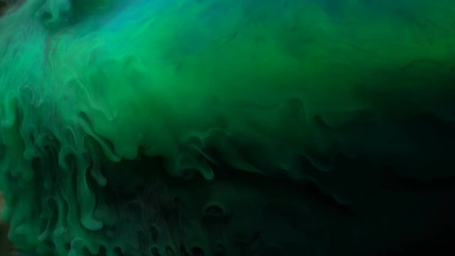 Colorful green, blue paint mixing in water. Colored acrylic cloud abstract smoke wave animation. Ink slow swirling underwater.