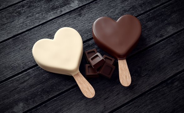 Two ice creams with heart shape and ounces of chocolate on wood