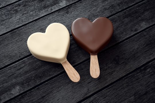 Two ice creams with heart shape on wood