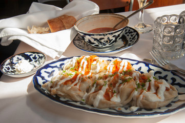 Manti: traditional Russian dumplings with a bowl of borscht (beet soup)