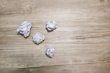 Crumpled paper ball on a black background.