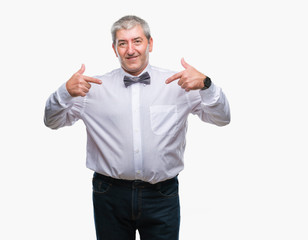 Handsome senior man wearing bow tie over isolated background looking confident with smile on face, pointing oneself with fingers proud and happy.