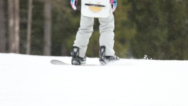 Snowboarder going down from mountain slope, closeup. Winter vacation
