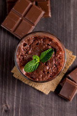 Chocolate, coffee, milk, banana shake on wooden background. Smoothie with mint. Milkshake. Protein diet. Healthy food and drink concept.