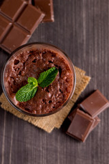 Chocolate, coffee, milk, banana shake on wooden background. Smoothie with mint. Milkshake. Protein diet. Healthy food and drink concept.