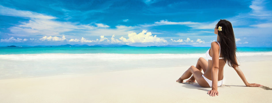 Happy Woman On The Beach Of Ocean. Enjoying Every Moment. Summer Vacation 