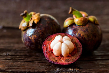 Mangosteen fruit on wooden table close up