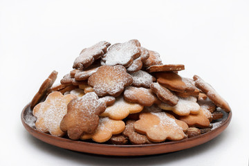 Original cookie flowers dusted with icing sugar on a white background isolated