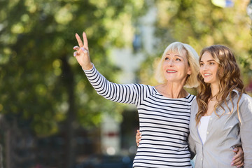 Happy mother and daughter bird watching in park
