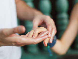 Close to the female hands of the masseur make a point massage of the hands in the cosmetology room