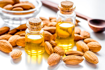 organic cosmetic with almond extract on table background