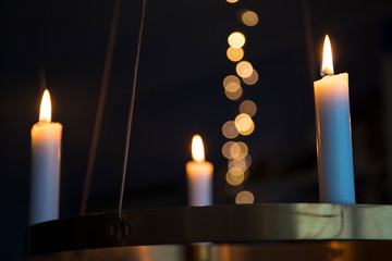 Candles glowing on advent chandelier.