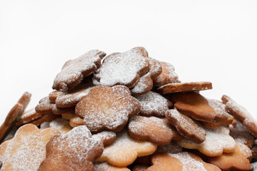 Original cookie flowers dusted with icing sugar on a white background isolated
