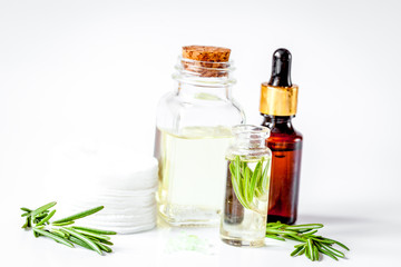 organic cosmetics with extracts of herbs rosemary on white background