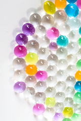 many multicolor orbiz on white background, growing balls in water, useful toy for plant
