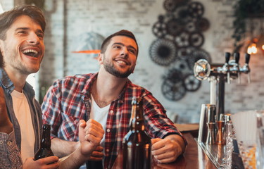 Men watching football match in sport bar