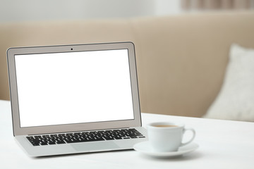 Fototapeta premium Laptop with blank screen on table indoors. Space for text