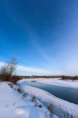 winter landscape. the river didn't freeze completely. panorama of the sky and the river. vertical frame
