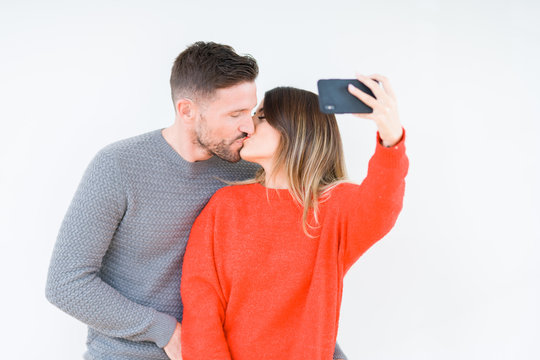 Beautiful young couple in love, kissing and hugging each other taking a selfie picture