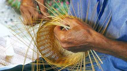 hand weaving a bamboo basket