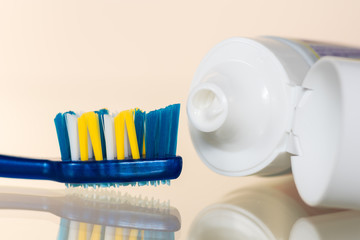 Toothpaste on a toothbrush on a white or colored background