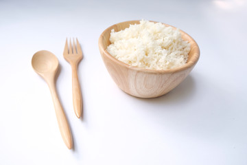 Hot steamed rice in a wooden bowl on a white background isolated