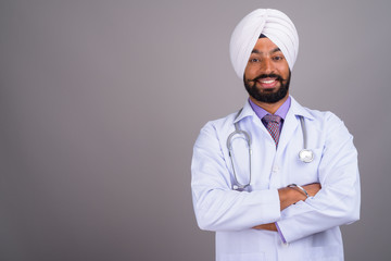 Portrait of young Indian Sikh man doctor smiling