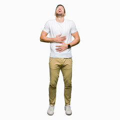 Fototapeta premium Handsome man wearing casual white t-shirt Smiling and laughing hard out loud because funny crazy joke. Happy expression.