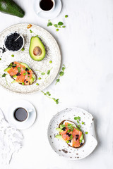 sandwich with avocado and salmon on a light background