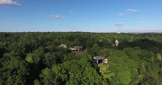 Flying Sideways With Houses In Forest Mountain Trees