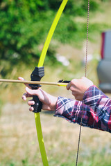 Hand holds archery and arrow