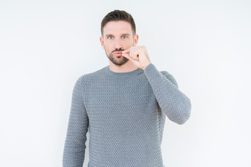 Young handsome man wearing casual sweater over isolated background mouth and lips shut as zip with...