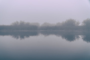 Fog in the early morning on a small lake