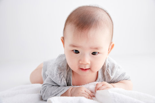 Closeup Asian baby lying on the clean ground
