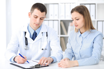 Doctor and  patient  sitting at the desk. Medicine and health care concept