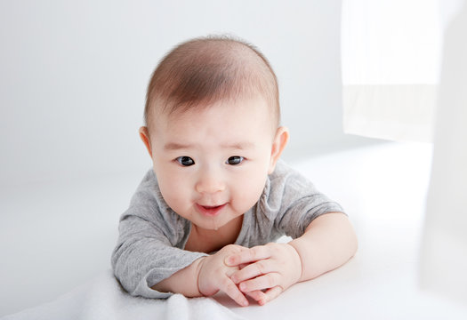 Closeup Asian baby lying on the clean ground