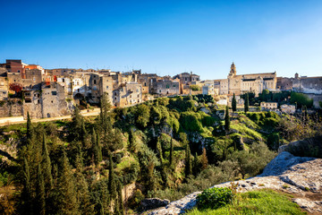 Fototapeta na wymiar Gravina in Puglia: picturesque landscape of the the deep ravine and the old town with the ancient cathedral, Bari, Italy